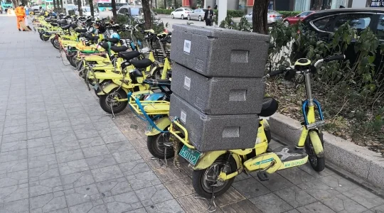 アリババ系 ハイテクスーパーマーケットで配送を待つ電動バイクと荷物